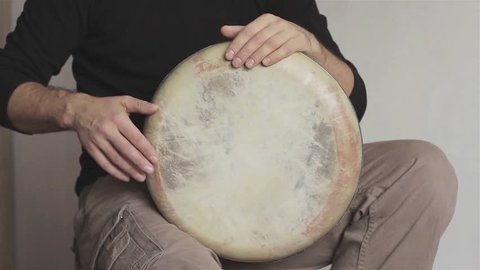 Man musician plays ethnic handmade drum darbuka close up. Male hands tapping djembe bongo hands movement rhythm. Musical instruments world culture sound