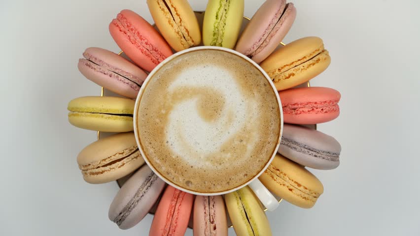 Pastel macarons around a coffee cup Royalty-Free Stock Footage #1008001672