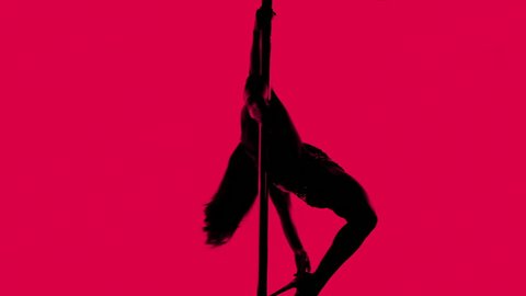 amazing pole dancer showing her skills against a white background
