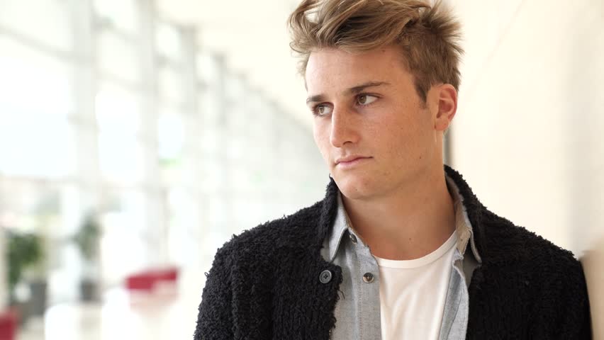 Young man standing in college hall