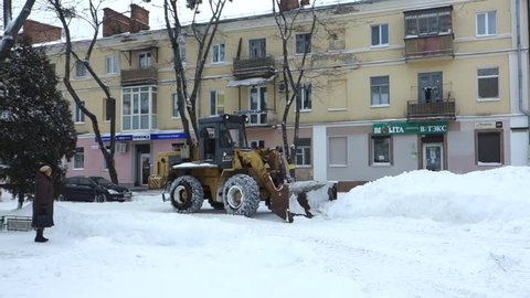 POLTAVA, UKRAINE - FEBRUARY 28, 2018:  snow sweeper works on the snowy street 