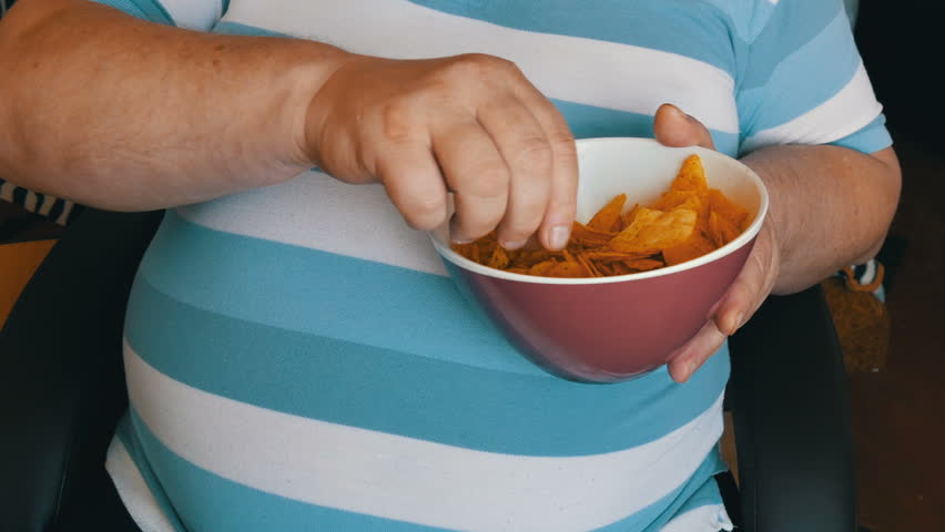 fat lazy man eating potato chips Stock Footage Video (100% Royalty-free ...