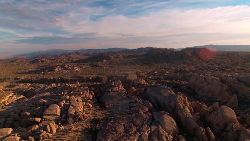 Stunning cinematic aerial over Joshua Tree National Park during golden hour