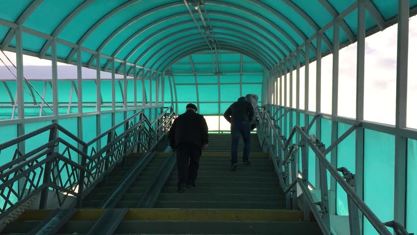 Tunnel transition stairs across the road. Russia is a transition for people across the road. People walk along the stairs outdoors