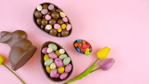 Happy Easter overhead with Easter eggs and decorations on a wood table background