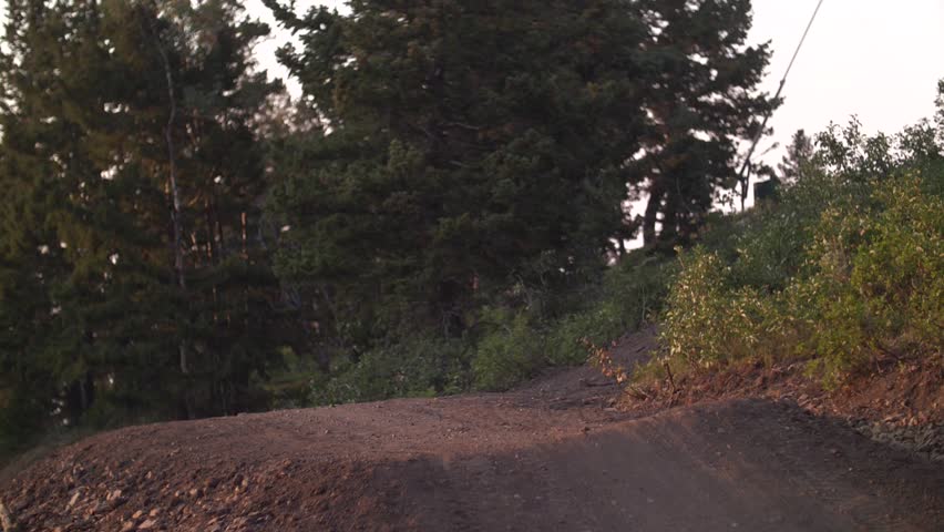 Down Hill Biker Jumping In Slow motion During Sunset  