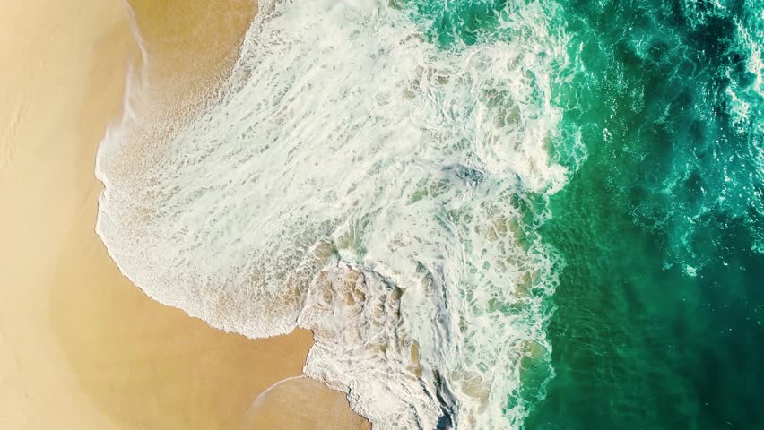 Aerial view waves break on white sand beach. Sea waves on the beautiful beach. drone 4k shot. zoom in Royalty-Free Stock Footage #1008056791