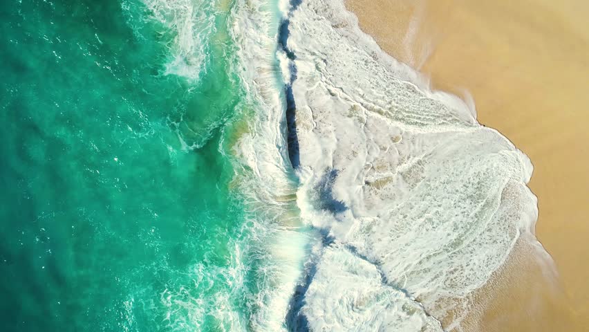 Aerial view waves break on white sand beach. Sea waves on the beautiful beach. drone 4k shot. zoom out Royalty-Free Stock Footage #1008056794