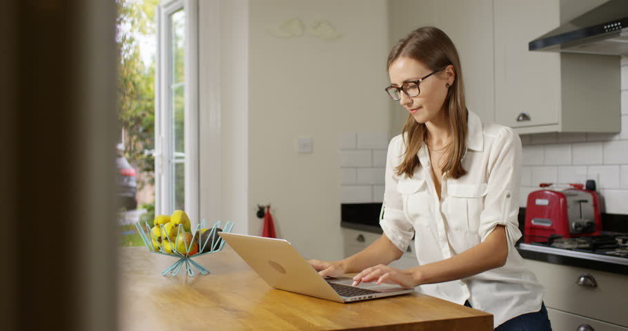 4k, Young happy and cheerful businesswoman working on a laptop from home. | Shutterstock HD Video #1008059638