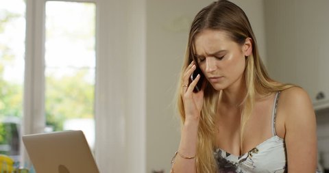 4K Very upset professional woman reacting to being given bad news over the phone