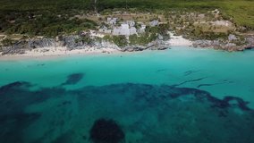 Ruins of Tulum - Ancient city of Maya. Amazing view of the old town and beautiful beach. Aerial view, video shot by drone 4k