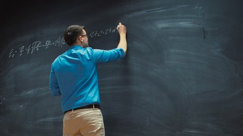 Time-Lapse of the Brilliant Young Mathematician Writing Formula on the Blackboard. Shot on RED EPIC-W 8K Helium Cinema Camera.