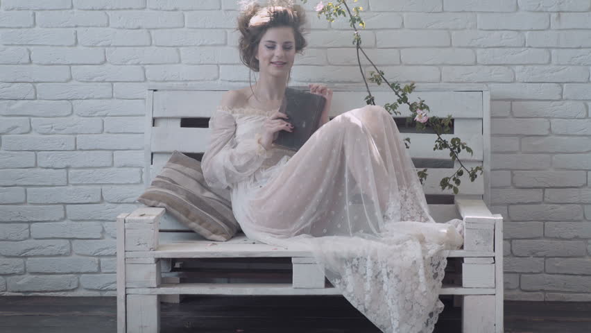 Cute girl reading a book. Victorian girl with book.