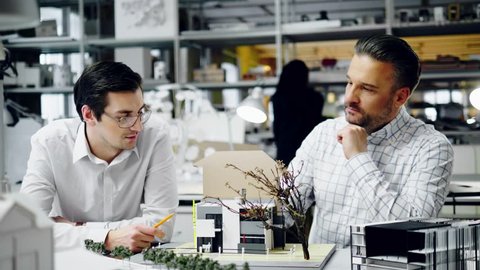 Two men working in design and engineering architecture office.