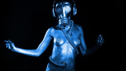 sexy woman dances in silver body paint with a gas mask covered in sparkling crystals. this is a special handmade item from our studio. how to survive the apocalypse in bling bling style