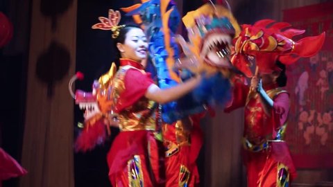 Moscow, Russia - February 03, 2018: girls from Taiko In-Spirational asian drum show in traditional asian costumes perform dance with dragons during the Asian new year concert.