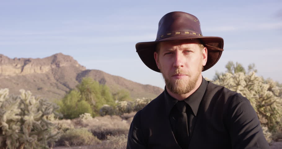 American Cowboy tips cowboy hat towards camera