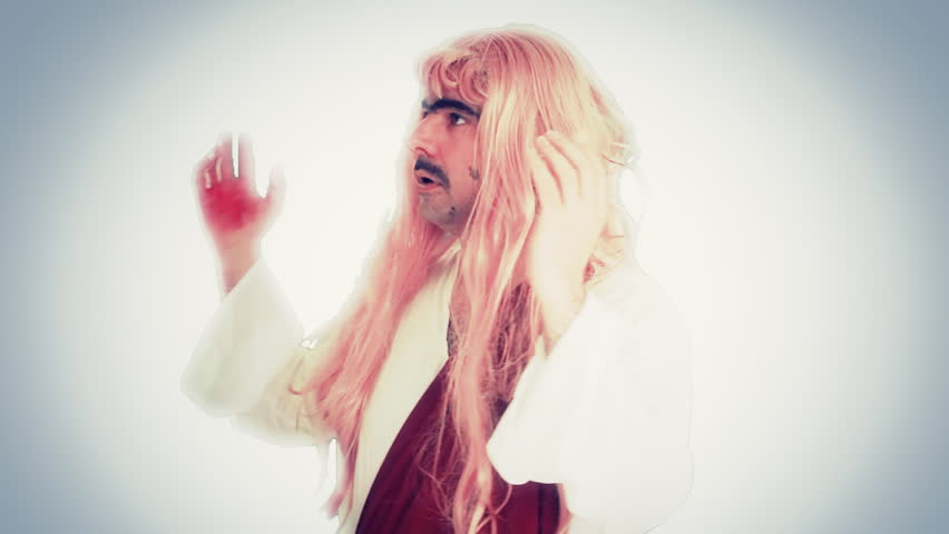 An ugly man dressed as a saint with a tunic and a blonde wig, screaming and making gestures. Funny comedy character. Medium close-up shot.
 Royalty-Free Stock Footage #1008104458