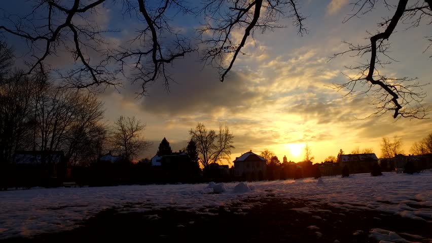 Silhouettes of houses in sunset on a cold winter evening.