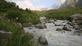 Movement of water flows in a stormy river in the Caucasus mountains in summer