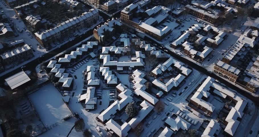 Sweeping drone footage of residential buildings in South West London, England, after a rare snowstorm in March, 2018. | Shutterstock HD Video #1008134644