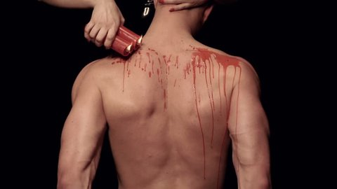 Dripping wax on a male body