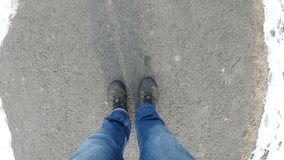 Walking in jeans around the asphalt road on winter city. Video footage 