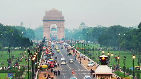 Delhi, India. Time-lapse of Car and people traffic to the India Gate in Delhi in the evening. Zoom in