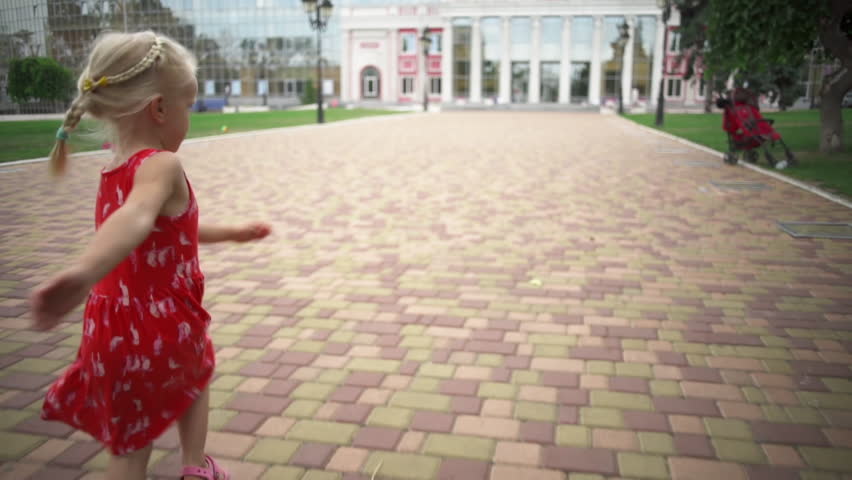 Small blonde girl running in the park sunny day rapid slow motion