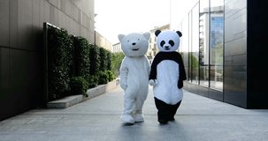 Two friends wearing animal costumes walking and having fun in the city