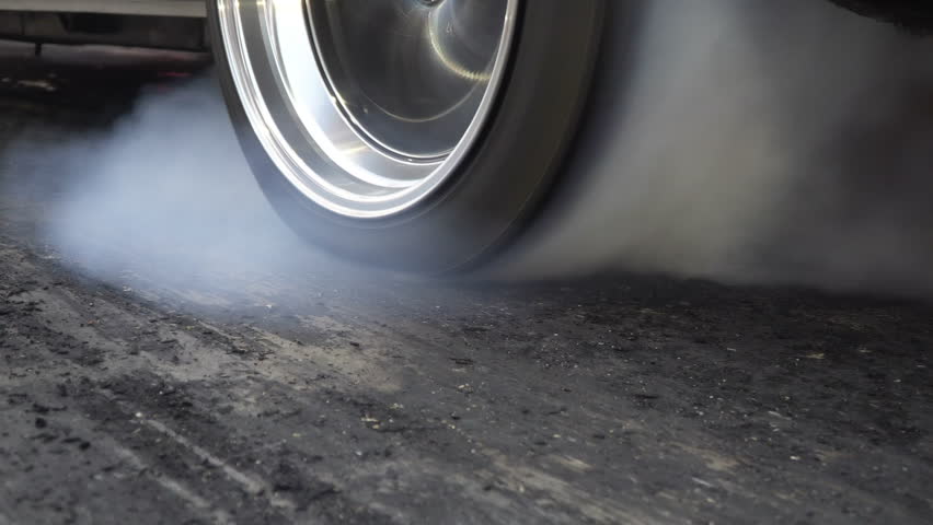 Drag racing car burn tire at start line