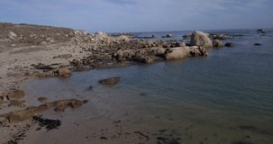 4K high quality aerial video footage of Western Cape's coast, Paternoster beach boulders, sandy sea front and Atlantic Ocean views in the background near Cape Town, South Africa on summer morning