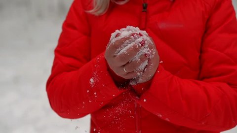 Ukraine, Oleshki, February 28, 2018. Woman sculpts a snow ball with her hands