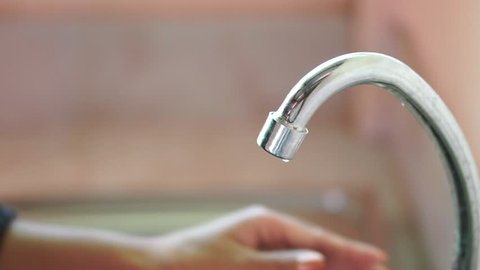 woman hand stop water running from faucet, save environment,ecology concept