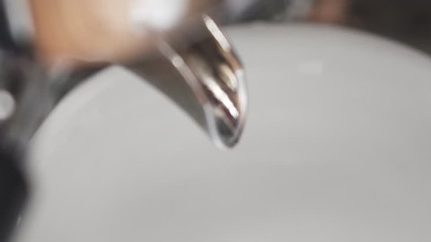 Slow motion handheld shot of coffee brew in cappuccino cup from above