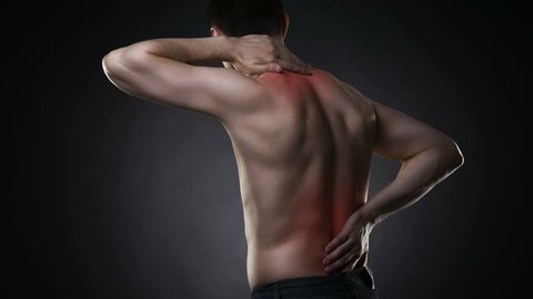 Back pain, man with backache on black background with red dots