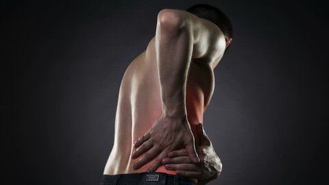 Back pain, kidney inflammation, ache in man's body on black background with red dot