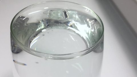 Water in a glass freezes and turns into ice