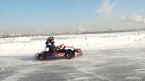 Winter karting competition on the ice track. Clip. Motion of go kart race in winter