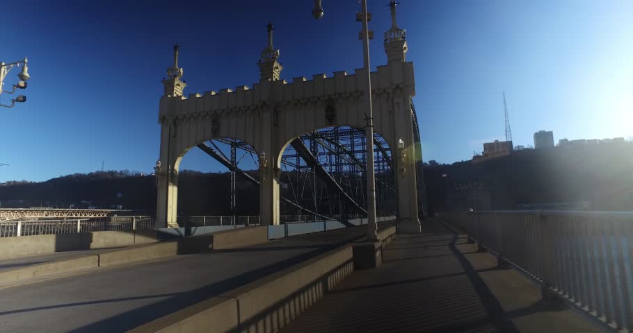 A pedestrians personal perspective walking on the Smithfield Street Bridge over the Monongahela River in downtown Pittsburgh, Pennsylvania.  	