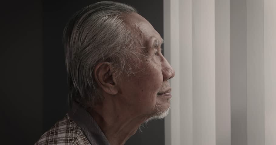 Slow motion footage of an elderly man smiling at the camera while standing near the window at home. Shot in 4k resolution Royalty-Free Stock Footage #1008185002
