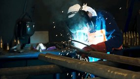 Worker welding construction by MIG welding. Clip. Worker welding the steel part by manual