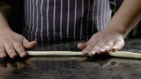 chef preparing traditional noodles with dough