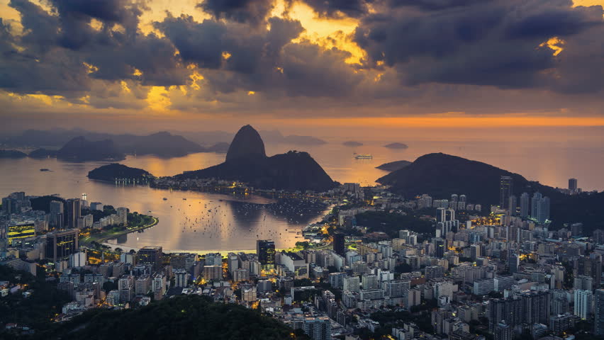 Sunrise over Sugarloaf Mountain in  Rio de Janeiro, Brazil. High angle view with reflection of the rising sun on water Royalty-Free Stock Footage #1008196519
