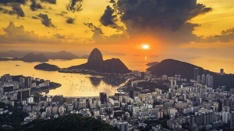 Sunrise over Sugarloaf Mountain in  Rio de Janeiro, Brazil. High angle view with reflection of the rising sun on water