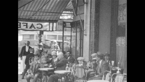 1920s: Men try to sell blankets to people waiting in vehicles. People sitting at tables outside caf?.