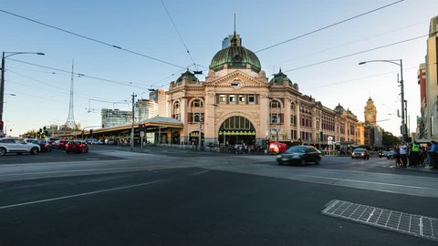 Melbourne, Victoria, Australia - March 5 2018: Timelapse Establishing shot of city. Flinders Street Station intersection in late afternoon with commuters and traffic. 4K Pro Res HQ video. No birds.