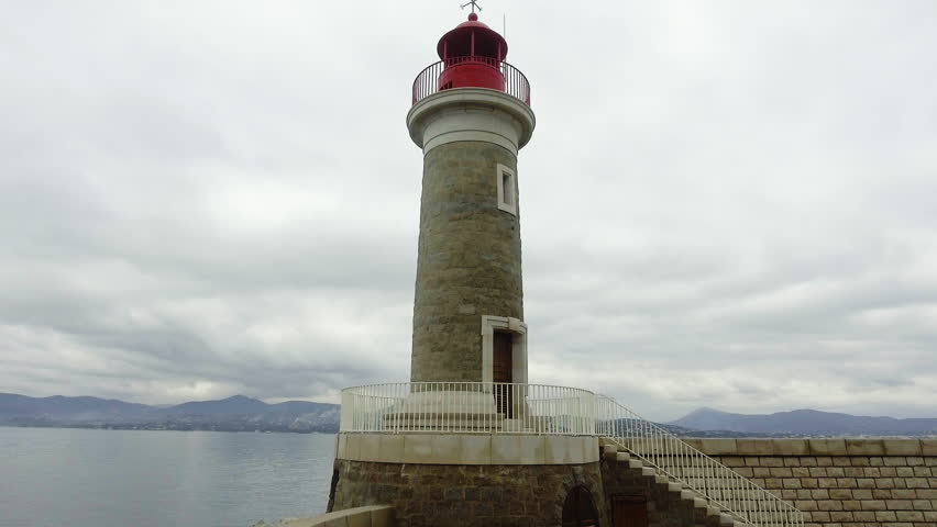 Aerial view of woman enjoying the view near lighthouse