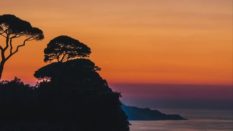 Beautiful time lapse sunset sun setting behind trees on Italy Hills in Sorrento, bast place in Italy