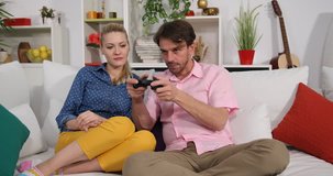 Happy Attractive Couple Play and Win a Games a Funny Activities Sitting on Sofa
